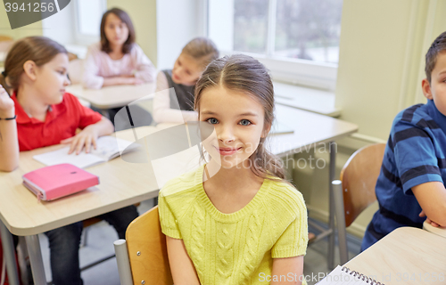 Image of student girl with group of school kids in class