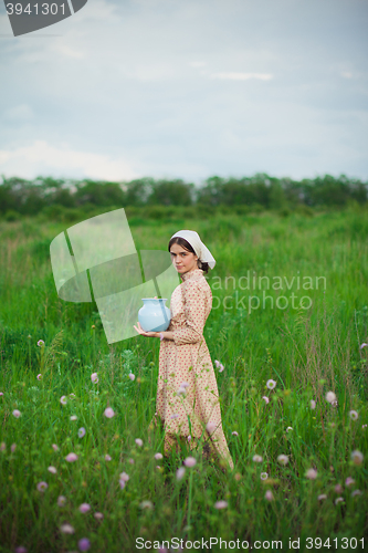 Image of The healthy rural life. The woman in the green field