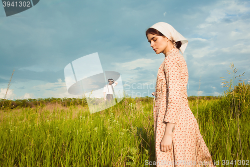 Image of The healthy rural life. The woman and man in the green field