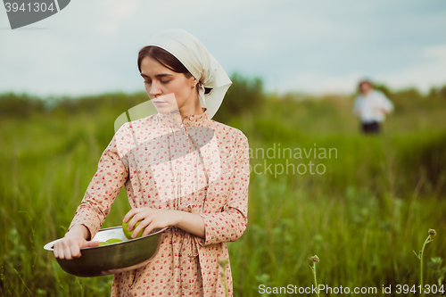 Image of The healthy rural life. The woman in the green field