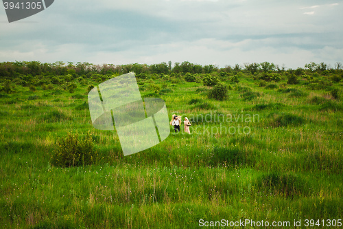 Image of The healthy rural life. The woman and man in the green field