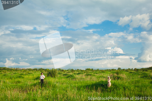 Image of The healthy rural life. The woman and man in the green field