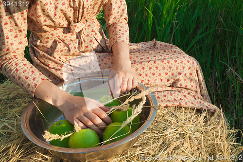 Image of The healthy rural life. The woman in the green field