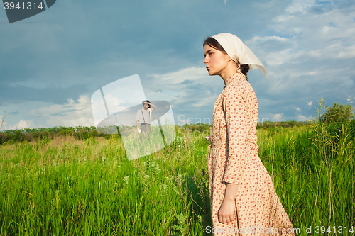 Image of The healthy rural life. The woman and man in the green field
