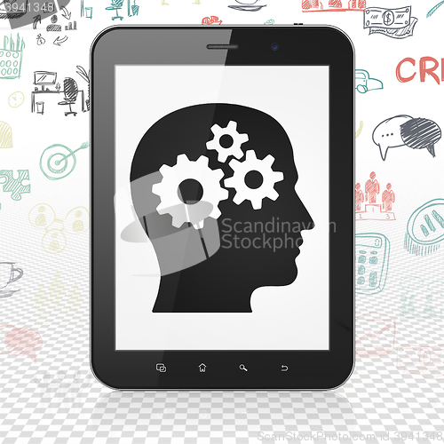 Image of Finance concept: Tablet Computer with Head With Gears on display