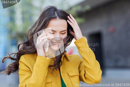 Image of smiling young woman or girl calling on smartphone