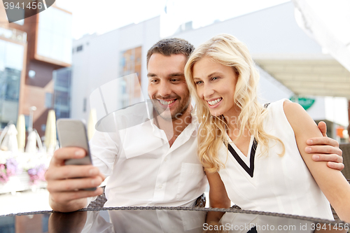 Image of couple taking selfie with smatphone at restaurant