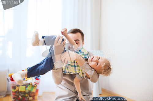 Image of father with son playing and having fun at home