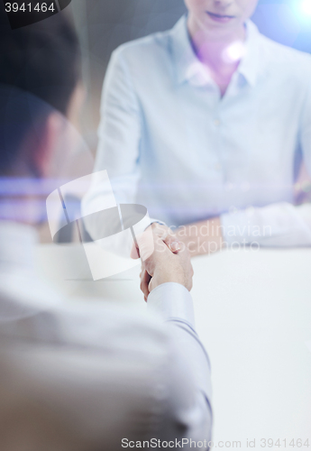 Image of businesswoman and businessman shaking hands