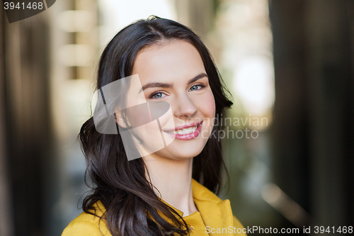Image of smiling young woman in city
