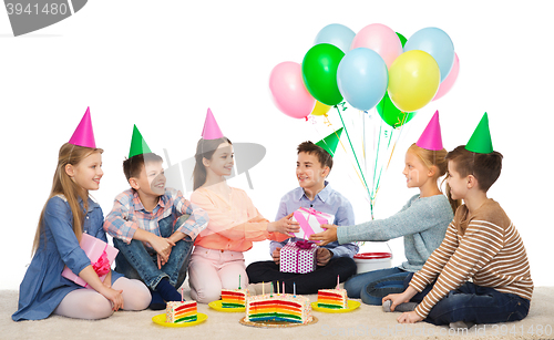 Image of happy children giving presents at birthday party