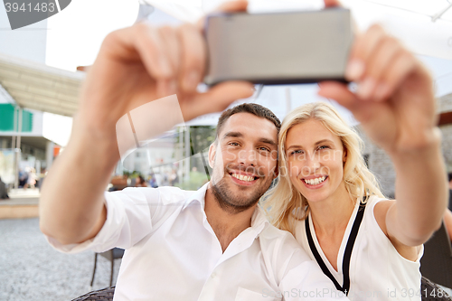 Image of couple taking selfie with smatphone at restaurant