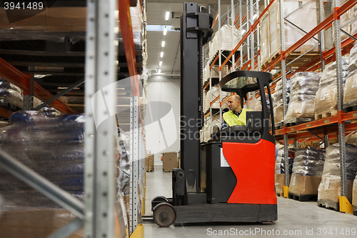 Image of man on forklift loading cargo at warehouse