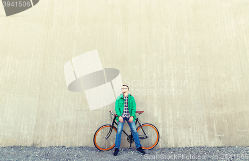 Image of happy young hipster man with fixed gear bike