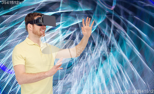 Image of happy man in virtual reality headset or 3d glasses