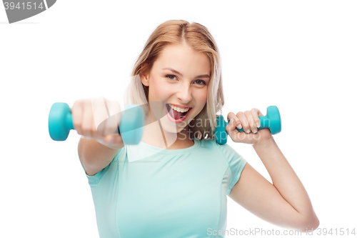 Image of smiling beautiful young sporty woman with dumbbell