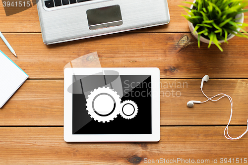 Image of close up of tablet pc computer on wooden table