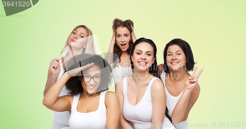 Image of group of happy women in white underwear having fun