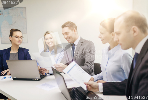 Image of business team with laptop having discussion