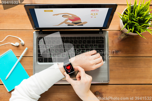 Image of close up of woman with smart watch and laptop