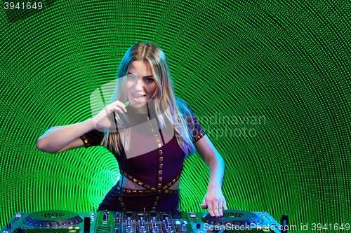 Image of DJ girl on decks at the party