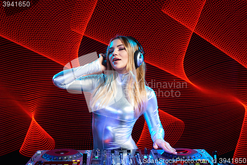 Image of DJ girl on decks at the party
