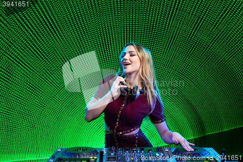 Image of DJ girl on decks at the party