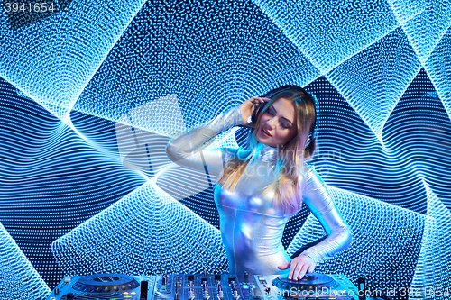 Image of DJ girl on decks at the party