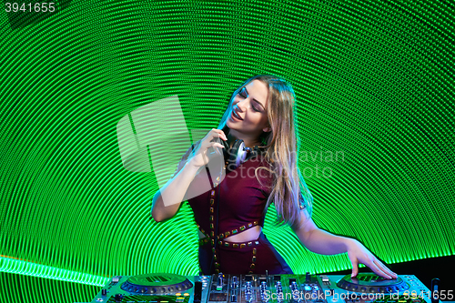 Image of DJ girl on decks at the party