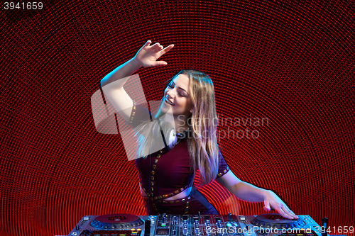 Image of DJ girl on decks at the party