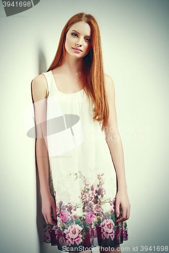 Image of Beautiful female in sleeveless flower print summer dress