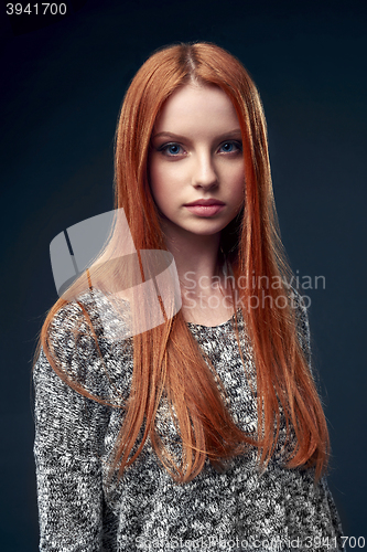 Image of Beautiful red haired female in grey sweater