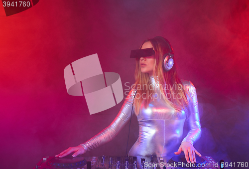 Image of DJ girl on decks at the party