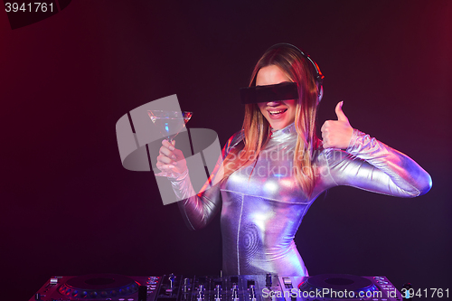 Image of DJ girl on decks at the party