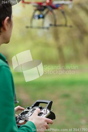 Image of Man controling a drone.