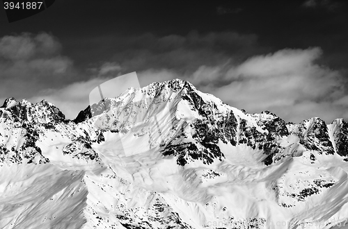 Image of Black and white snowy mountains at sun day