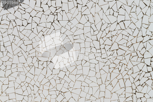 Image of White broken tiles wall