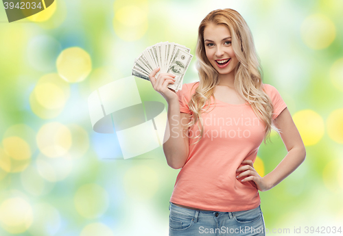 Image of happy young woman with usa dollar cash money