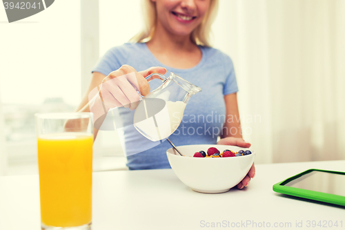 Image of close up of woman with milk jug eating breakfast