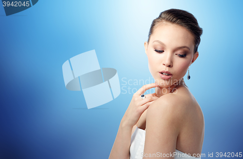 Image of beautiful woman with earring, ring and pendant