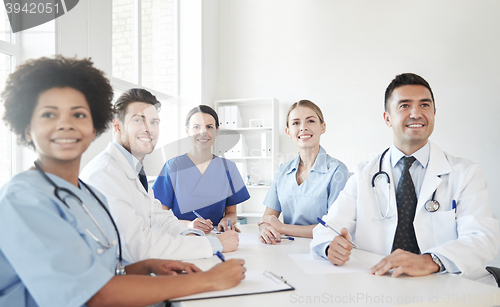 Image of group of happy doctors meeting at hospital office