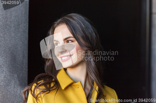 Image of smiling young woman in city