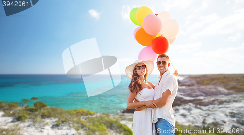 Image of smiling couple with air balloons outdoors