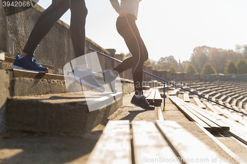 Image of close up of couple running downstairs on stadium