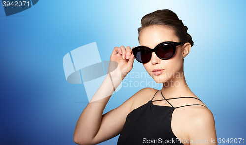 Image of beautiful young woman in elegant black sunglasses