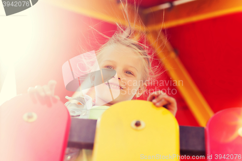 Image of happy little girl on children playground