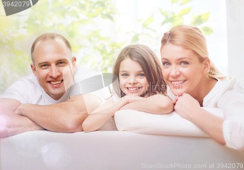 Image of smiling parents and little girl at home