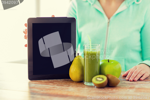 Image of close up of woman hands tablet pc and fruit juice