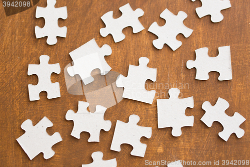 Image of close up of puzzle pieces on wooden surface