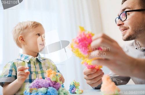 Image of father and son playing with ball clay at home